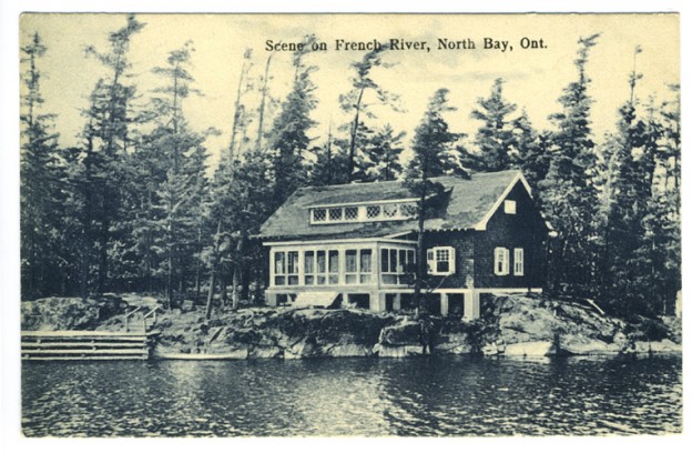 postcard showing a large house by the water