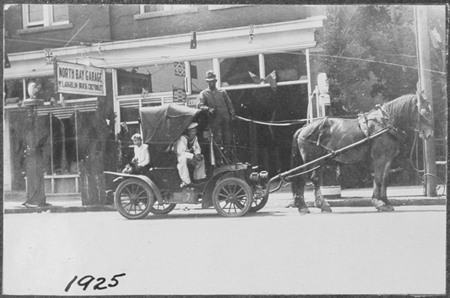 middle right photo on large album page (9 photos to page).  These are not titled in the album.  The float looks like a very small early car pulled by a horse.  On the bottom